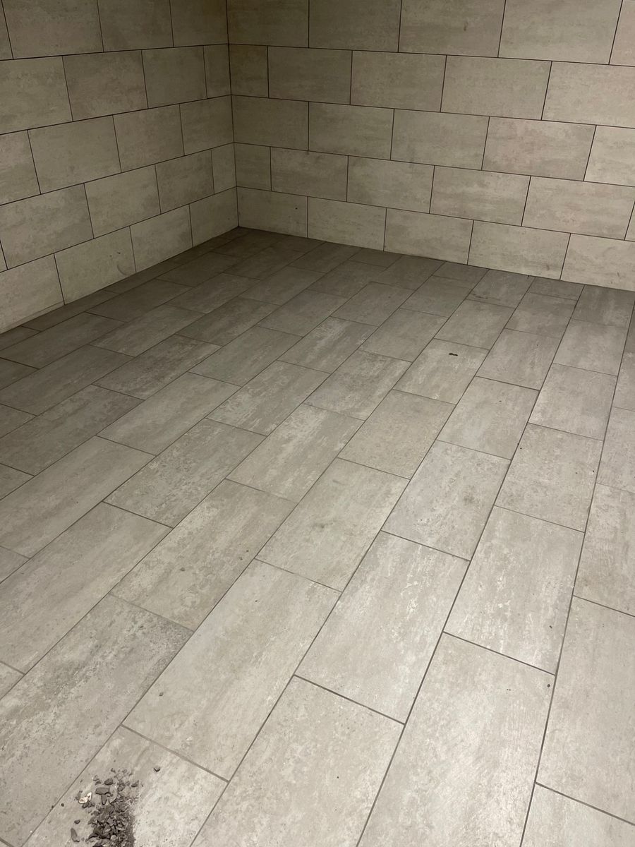Room tiled floor to walls in large-format gray tile